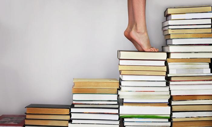 Escalera de libros con una persona subiendo